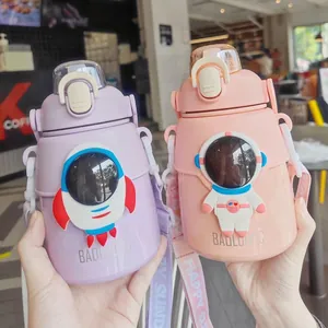Close-up of large purple and pink water bottles with rocket and astronaut 3D designs.