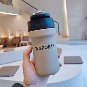 Handheld cream-colored stainless steel sports bottle with straw and black lid
