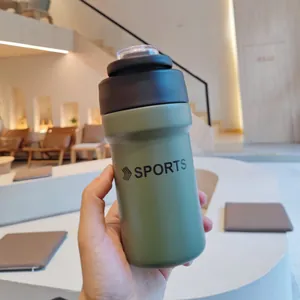 Close-up of green stainless steel sports water bottle with a dual-use drinking lid.