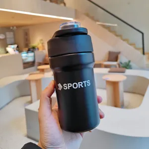 Close-up of a hand holding a black matte stainless steel sports water bottle