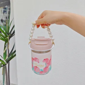 Portable tulip glass water bottle with elegant pearl handle and pink sleeve detail
