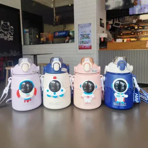 Four colorful astronaut themed big belly insulated water bottles displayed in a cafe setting