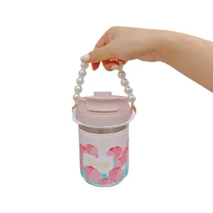 Pink tulip glass water bottle featuring a pearl carrying strap and decorative sleeve