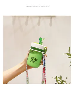 Detailed view of a portable green student water bottle with cute deer logo and strap