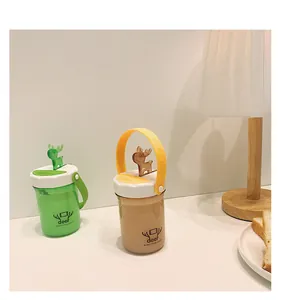 Cute deer plastic water cups with portable handle and phone holder feature shown in a cozy setting.