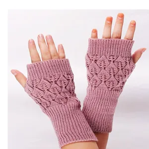 Close-up of pink hollow leaf pattern knitted fingerless gloves in acrylic material