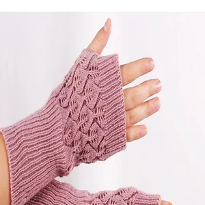 Detailed close-up view of pink knitted fingerless gloves with elegant hollow lace pattern