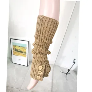 Detailed view of khaki knitted leg warmers featuring three wooden button accents