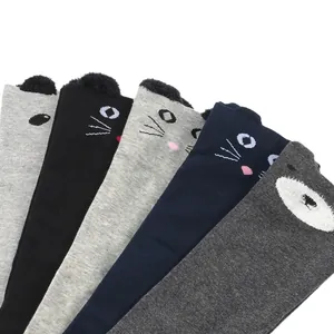 Detailed view of cute cat face patterns and fluffy ears on these over-the-knee socks