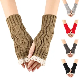 Detailed view of knitted fingerless gloves with hollow leaf pattern and white lace trim.