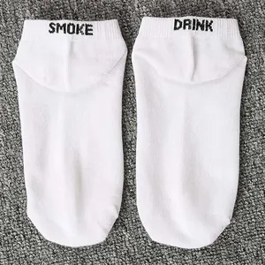 Close-up of white boat socks featuring black SMOKE and DRINK embroidery on heels