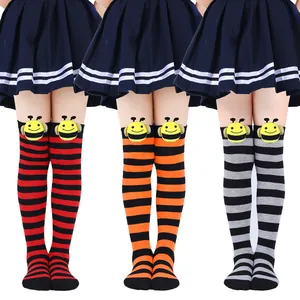 Detail view of children's striped over-the-knee socks with cute bee doll accents.
