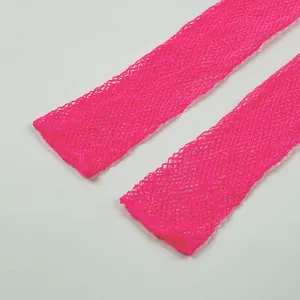 Close-up macro view of vibrant neon pink fishnet mesh texture for long party gloves accessories