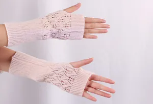 Detail of light pink knitted fingerless gloves with elegant hollow leaf pattern