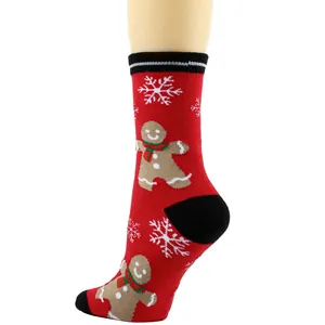 Side view of festive red Christmas socks showing gingerbread man and snowflake details.