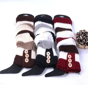 Close-up of three striped knitted leg warmers with three decorative wooden buttons