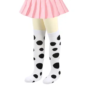 Detailed view of white children's knee-high socks with large black polka dot pattern
