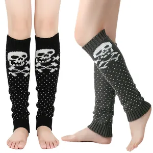 Close-up view of black and grey knitted leg warmers with white skull and crossbones