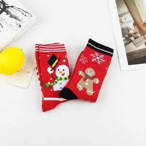 Detailed view of festive red Christmas socks with cute snowman and gingerbread man patterns.