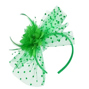 Detailed view of a green vintage fascinator headband with feathers and a dotted veil