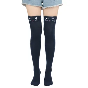 Close-up detail of the cute cat face pattern on navy blue over-the-knee socks for women