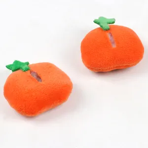 Detail showing two orange plush pumpkin charms for Halloween DIY brooch accessories