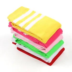 Close-up of stacked colorful striped knee-high socks for children in multiple vibrant colors
