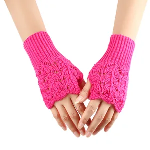 Detailed view of pink fingerless knit gloves with hollow heart pattern on hand