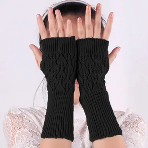 Close-up of black acrylic long fingerless gloves with intricate hollow knit pattern