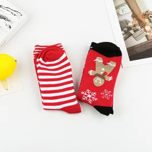 Detailed macro view of red festive Christmas crew socks with gingerbread and stripes