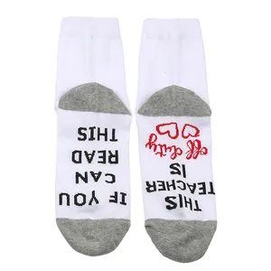 Detailed view of teacher off duty message printed on the sole of white cotton socks