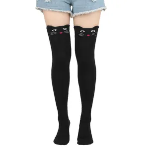 Detail view of cute black thigh-high socks with cartoon cat face embroidery