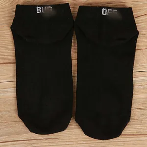 Detailed view of black cotton ankle socks featuring white 'BUG OFF' funny text design