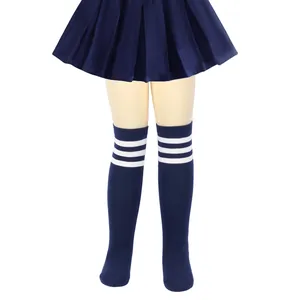 Close-up detail of navy blue children's knee-high socks featuring classic white triple stripes