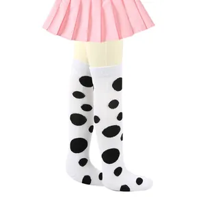 Close-up showing the soft cotton texture of girls white knee high polka dot socks