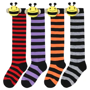 Four pairs of children's striped knee-high socks featuring cute plush bee dolls.