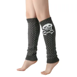 Detail view of knitted grey leg warmers featuring a white skull and polka dot pattern