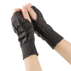 Close-up detail of dark brown knitted fingerless gloves showing thick diamond pattern