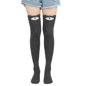 Detail of cute grey cat pattern thigh high socks with cartoon animal design on white background