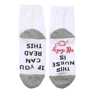 Close-up of white cotton nurse socks featuring a Nurse Is Off Duty slogan design