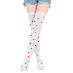 Detailed view of white over-the-knee socks with red heart patterns for Valentine's Day