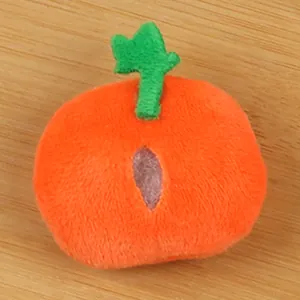 Detailed close-up of a small orange plush pumpkin toy for DIY craft and Halloween decor