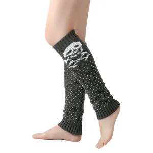 Detailed view of grey knitted leg warmers with white skull and polka dot patterns.