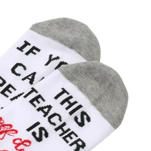Detail view of cotton socks with 'Teacher is Off Duty' printed message