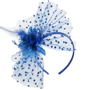 Macro detail of blue flower fascinator headband with feather and polka dot mesh