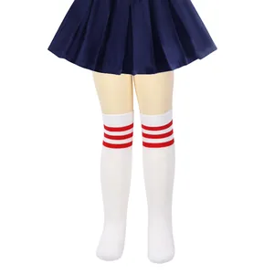 Detail view of white knit knee-high socks with three red stripes for girls
