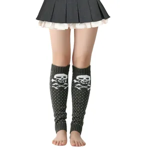 Detailed view of grey knitted leg warmers with white skull and crossbones pattern