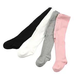 A collection of baby footed tights in four colors: black, white, grey, and pink.