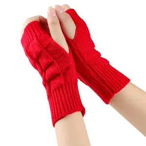 Detailed view of bright red knitted fingerless gloves with soft textured pattern