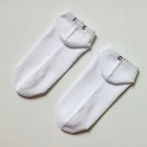 Minimalist white ankle socks featuring black embroidered 'FUCK OFF' text on the heel detail